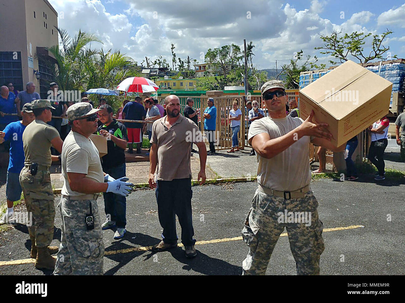 United States Army Reserve and Puerto Rico National Guard Soldiers assist  with food and water delivery to the San Antonio sector of Caguas, Puerto  Rico, October 24. The supplies were delivered to