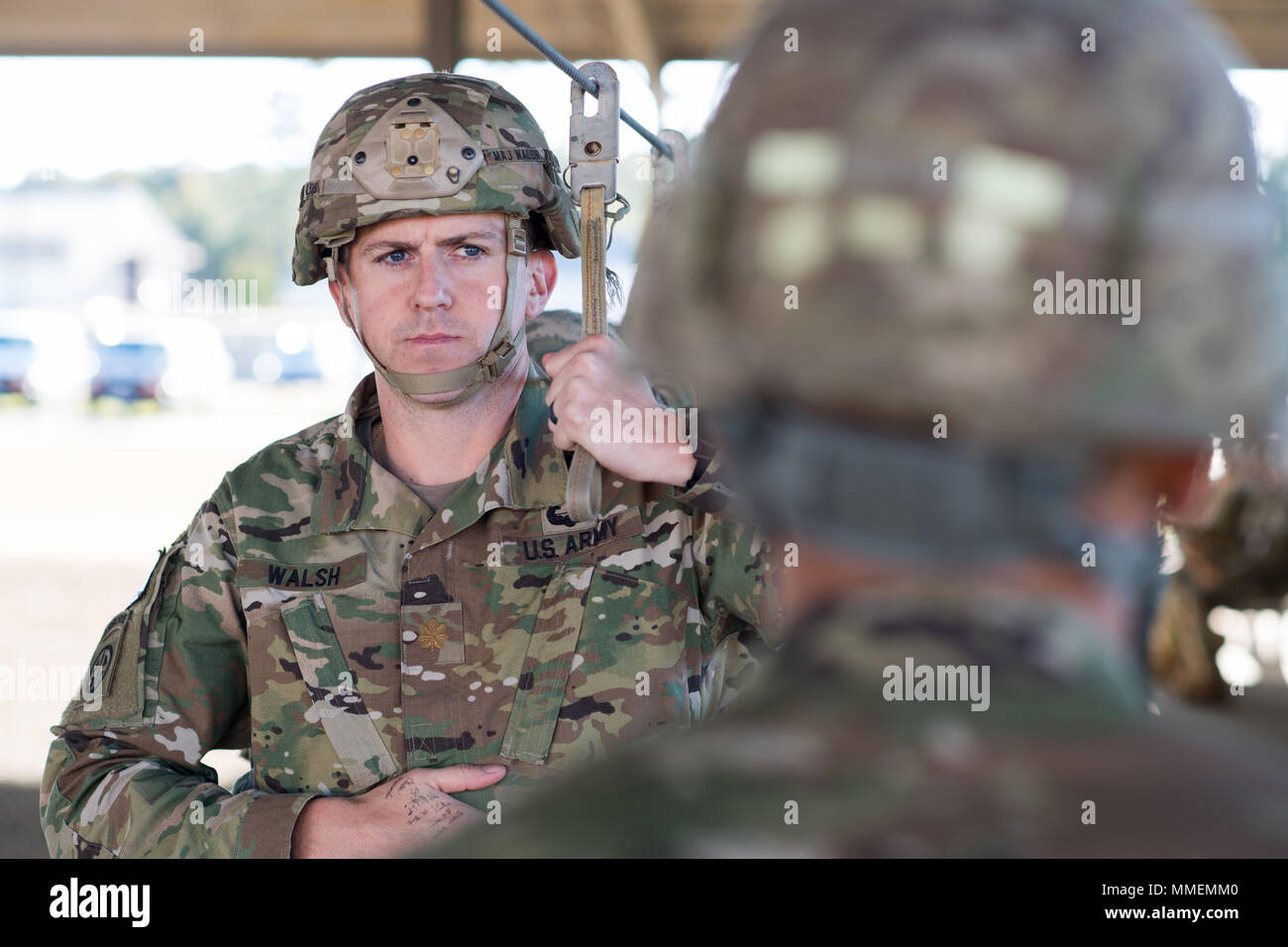 POPE ARMY AIRFIELD, N.C. — Army Maj. Chris Walsh, 82nd Airborne Division Artillery operations officer, listens to a jumpmaster while preparing for night training operations at Green Ramp here Oct. 26. Aircrews