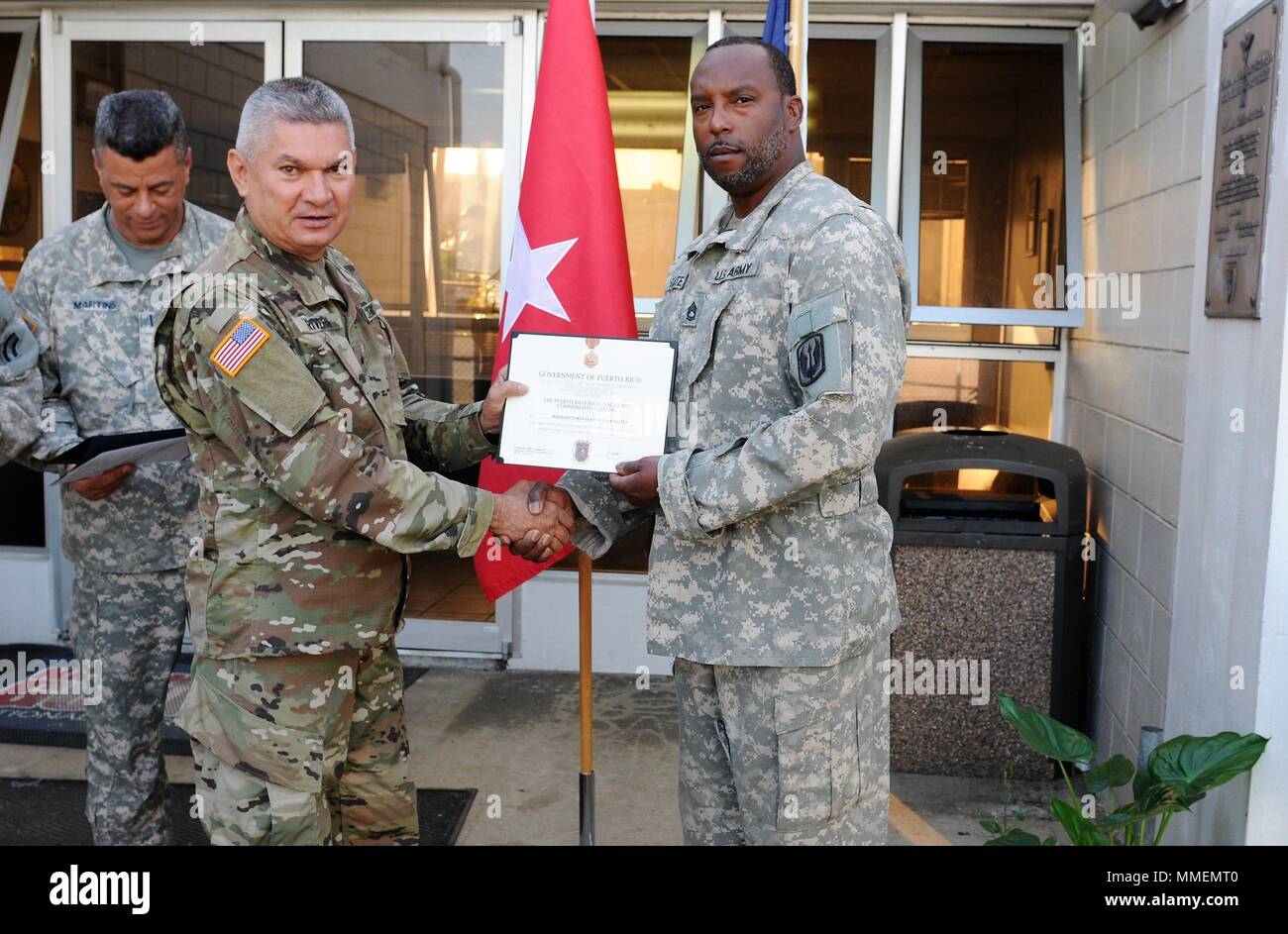 “GOVERNMENT OF PUERTO RICO, TO ALL WHO SHALL SEE THESE PRESENTS, GREETINGS: THIS IS TO CERTIFY THAT THE GORVERNOR OF PUERTO RICO HAS AWARDED THE PUERTO RICO NATIONAL GUARD COMMENDATION MEDAL TO…”      And that’s how today’s ceremony began when the Adjutant General of Puerto Rico, Isabelo Rivera, presented the Puerto Rico National Guard Commendation Medal to New York National Guards Citizen-Soldiers who came to support the relief efforts in the aftermath of Hurricane Maria.  Their presence didn’t just bring food, water and supplies to the affected citizens as a result of the Hurricane, they als Stock Photo