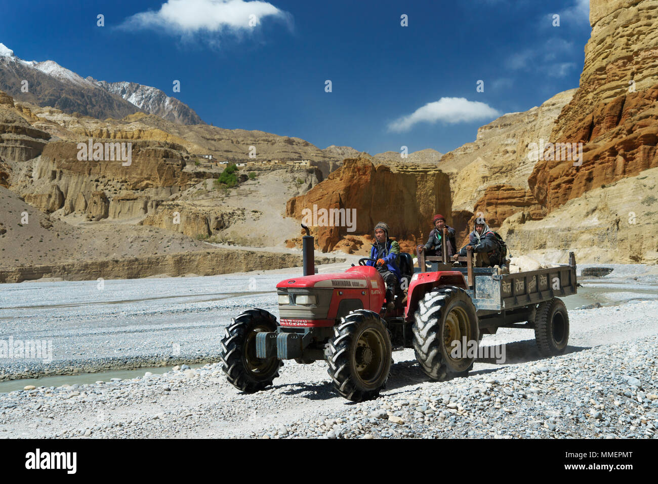 Loba workers travelling on a tractor along the dry river bed of the Kali Gandaki river near Chele, Upper Mustang region, Nepal. Stock Photo