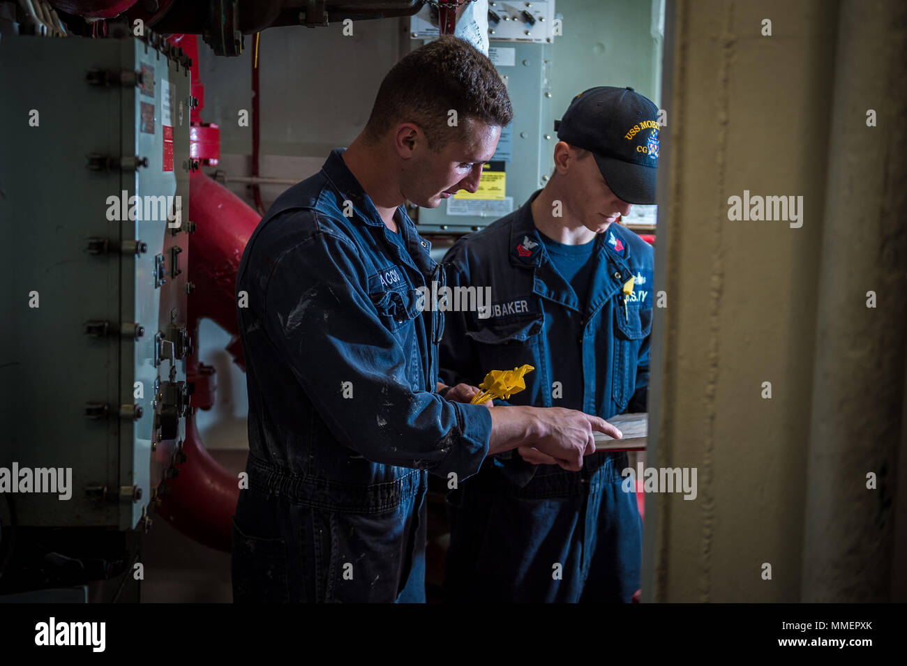 171021-N-KT595-043 PACIFIC OCEAN (Oct. 21, 2017) Damage Controlman 1st Class Gabriel Brubaker and Fireman Braden Braccio, assigned to the guided-missile cruiser USS Mobile Bay (CG 53), perform a daily inspection on the ships damage control equipment. Mobile Bay is currently underway testing an AEGIS Baseline 9 upgrade to its Baseline 8 combat system in preparation for its upcoming deployment. (U.S Navy Photo by Mass Communication Specialist 1st Class Chad M. Butler/Released) Stock Photo