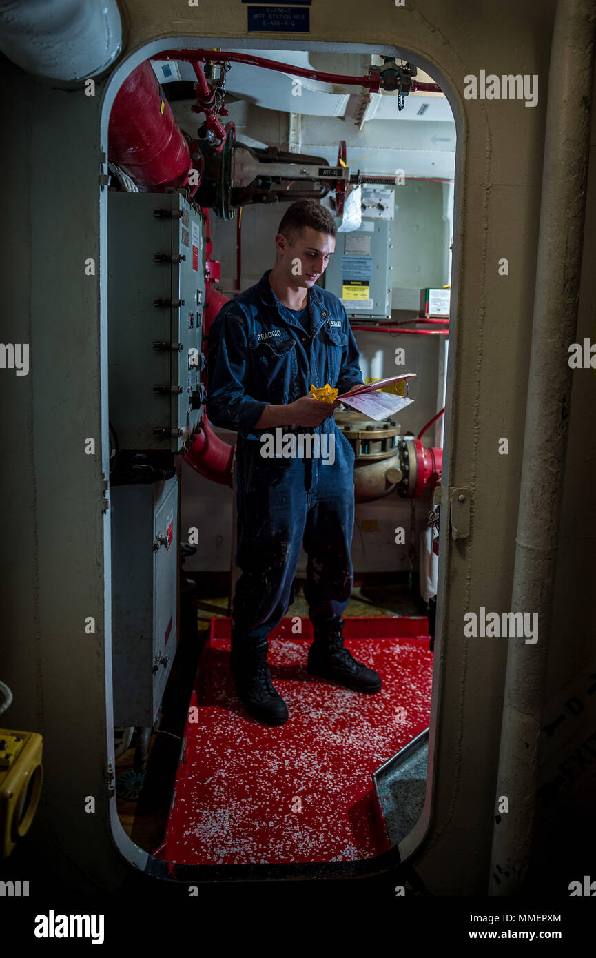 171021-N-KT595-046 PACIFIC OCEAN (Oct. 21, 2017) Damage Controlman Fireman Braden Braccio, assigned to the guided-missile cruiser USS Mobile Bay (CG-53), performs a daily inspection on the ships damage control equipment. Mobile Bay is currently underway testing the updated AEGIS Baseline 9 weapons system in preparation for its upcoming deployment. (U.S Navy Photo by Mass Communication Specialist 1st Class Chad M. Butler/Released) Stock Photo