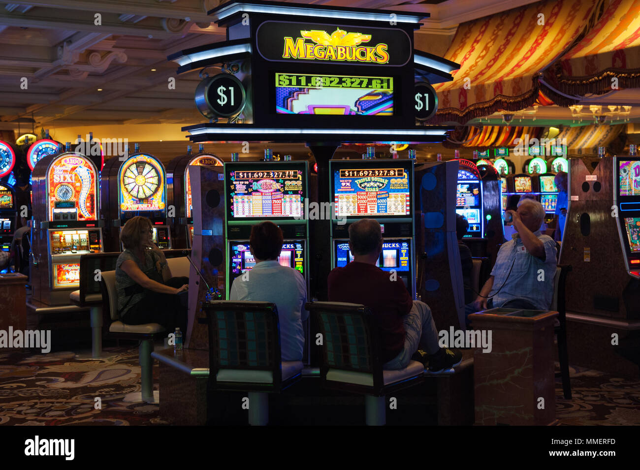 Gamblers playing Megabucks slot machines, Bellagio Casino, Las Vegas, Nevada. Stock Photo