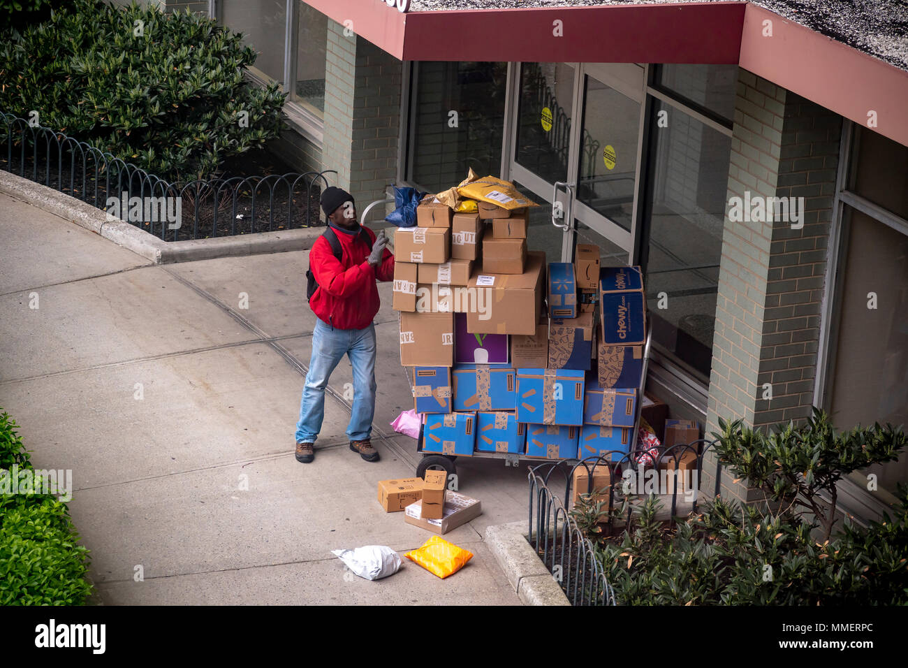 A deliveryman from Lasership with his cart laden with purchases from