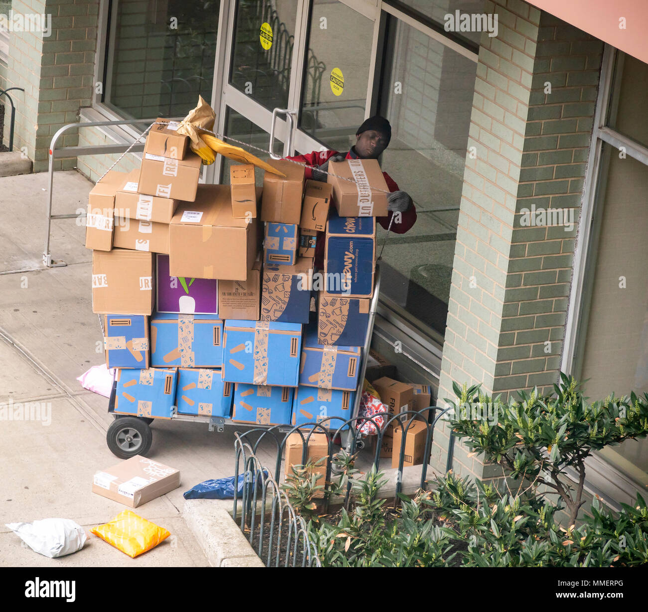A deliveryman from Lasership with his cart laden with purchases from
