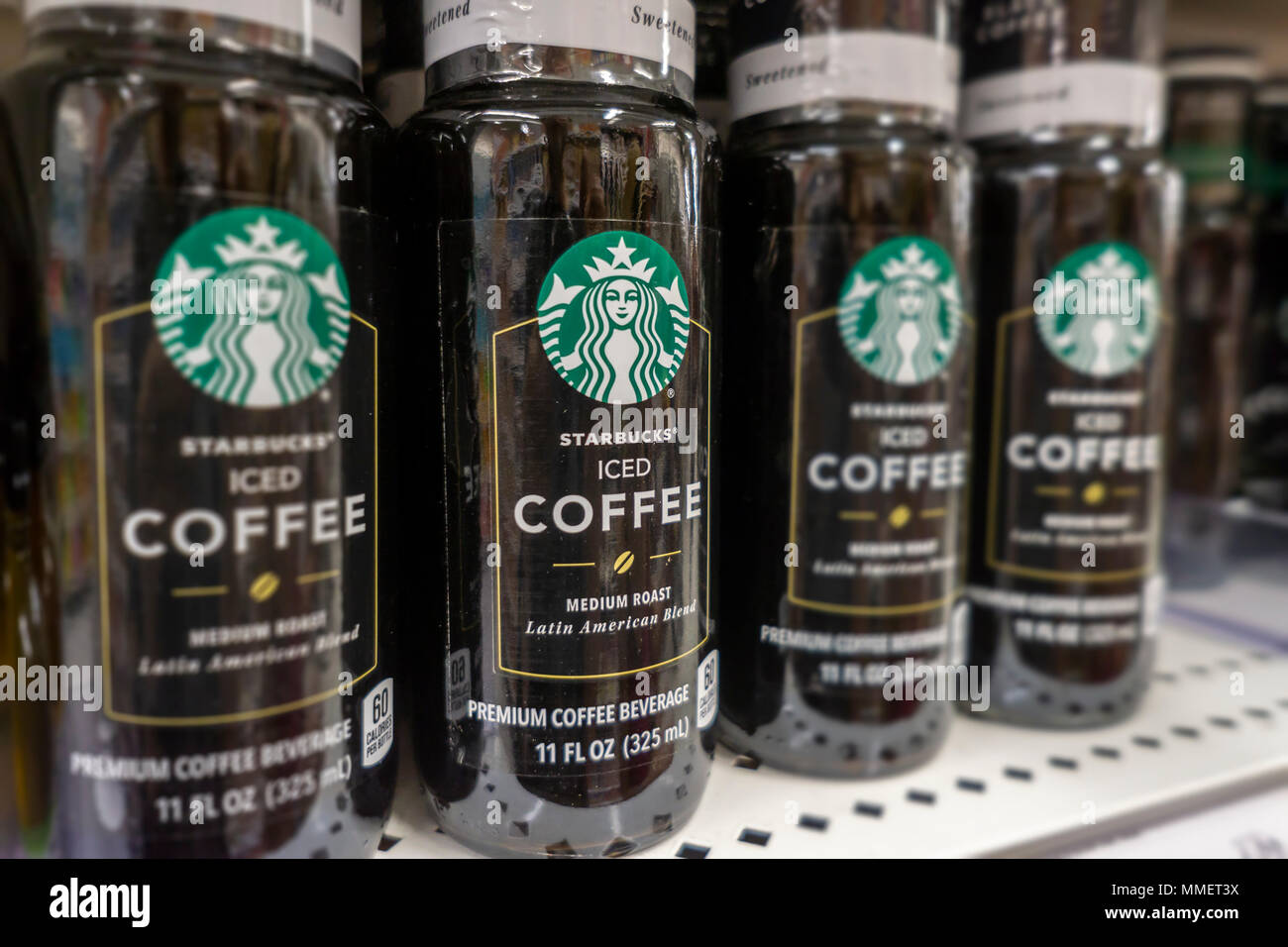 Bottles of Starbucks iced coffee are seen on a supermarket shelf in New York on Friday, May 4, 2018. NestlŽ is reported to be in talks to purchase Starbucks' grocery business. The units that sell beans and drinks in supermarkets and groceries are involved and not any of the stores. NestlŽ is the world's largest packaged food company. (© Richard B. Levine) Stock Photo