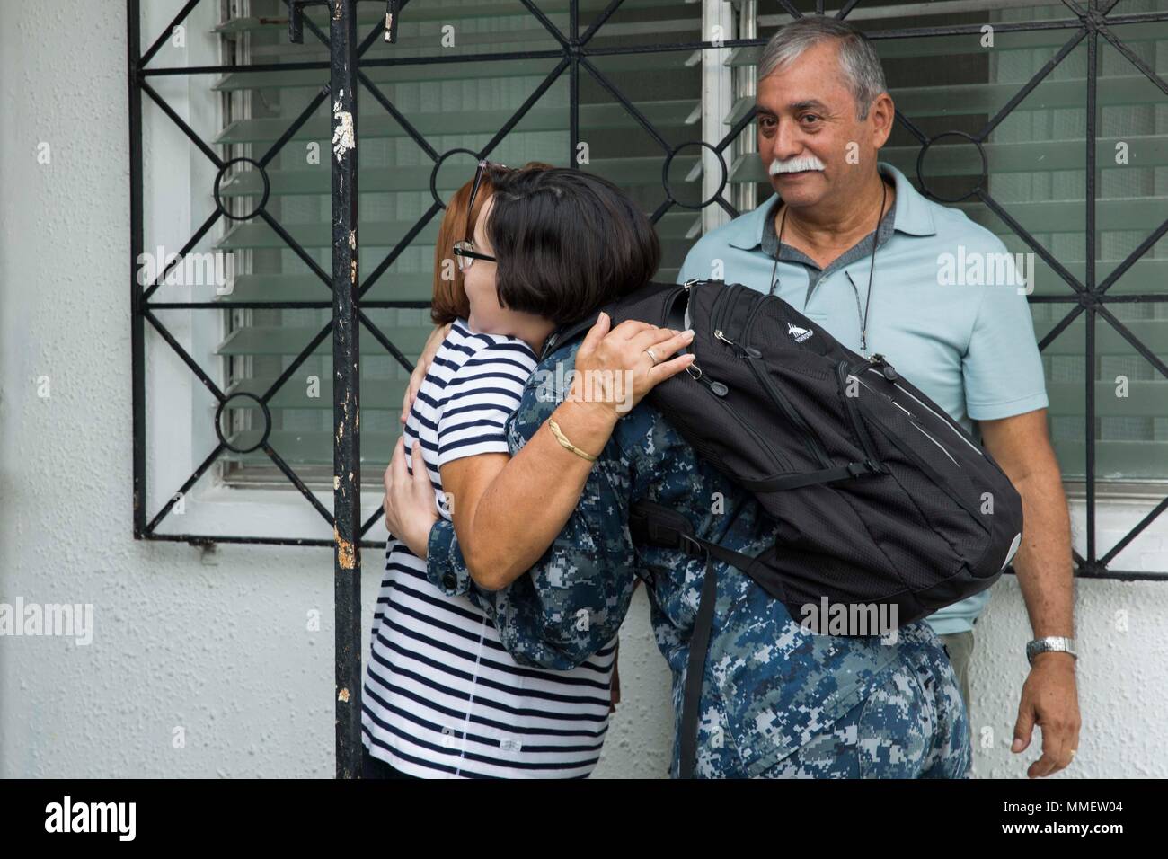 171027-N-MC499-024 BAYAMON, Puerto Rico (Oct. 27, 2017) Operations  Specialist Seaman Zabrina Adorno, assigned to the amphibious assault ship  USS Kearsarge (LHD 3), greets her uncle, Tony Hernandez, and her aunt,  Gladys Hernandez-Luna,
