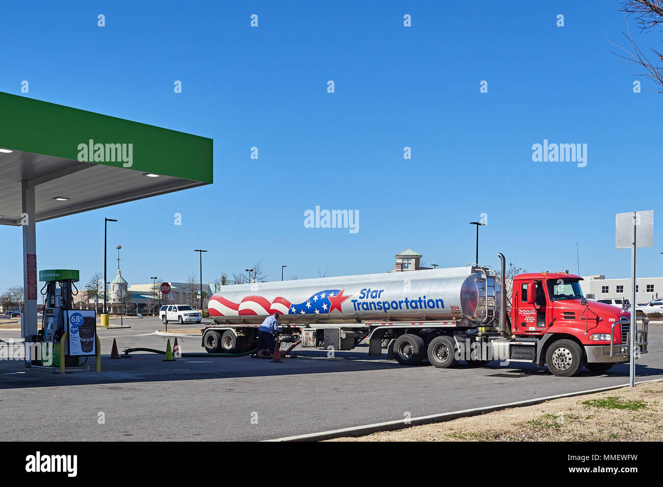 Gasoline or petrol tank truck supplying or off loading fuel at a retail gas station in Montgomery Alabama, USA. Stock Photo