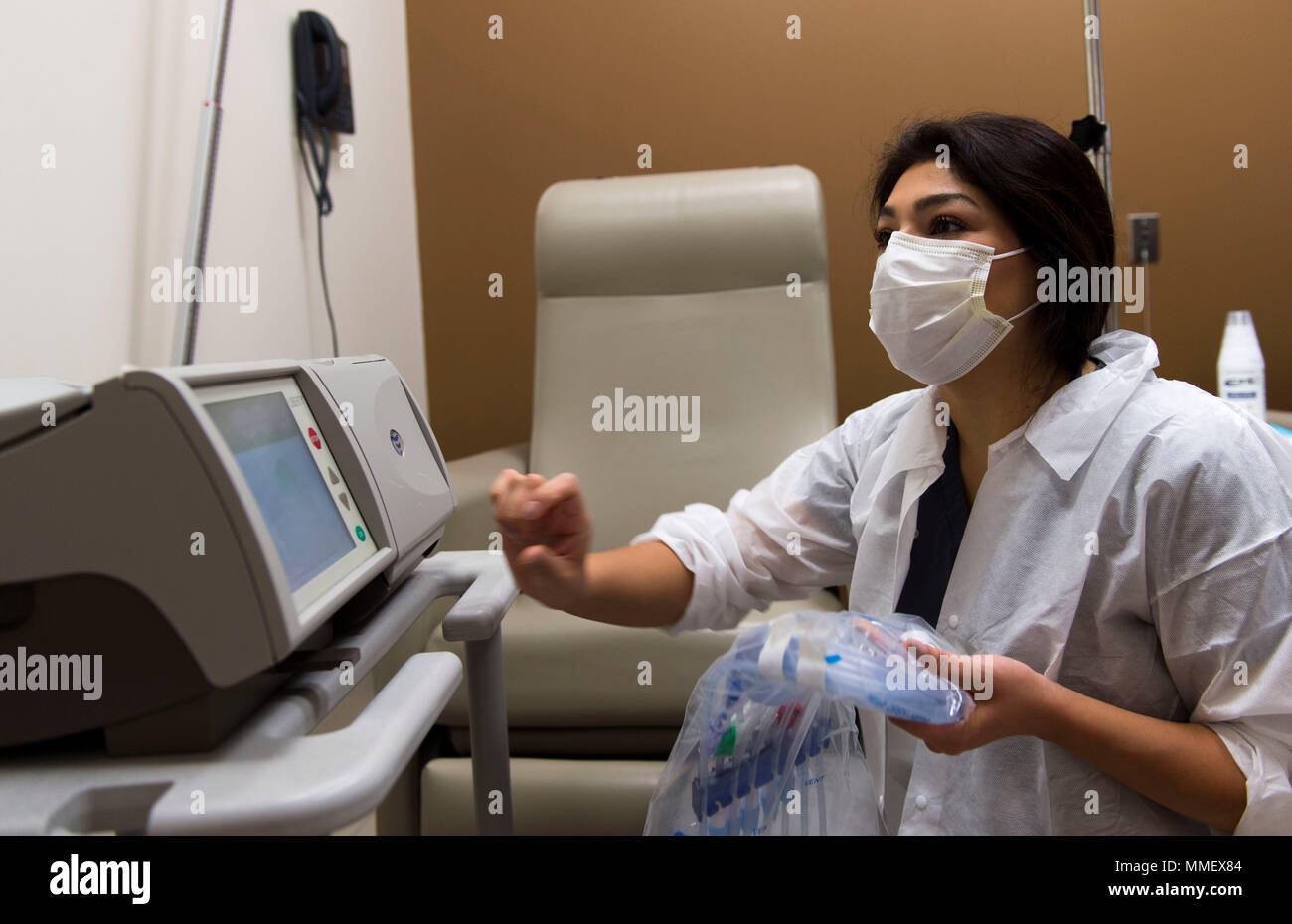 Nayeli Bustillos, a volunteer registered nurse, prepares a dialysis