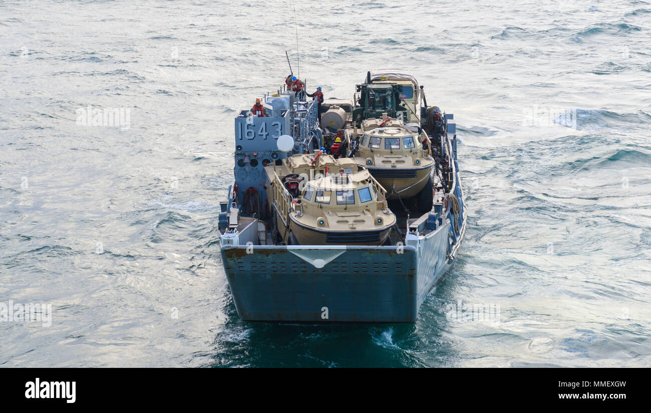 ATLANTIC OCEAN (Oct. 30, 2017) Landing craft utility 1643, attached to Assault Craft Unit (ACU) 2, departs the amphibious assault ship USS Iwo Jima (LHD 7). Iwo Jima is underway conducting routine operations at sea. (U.S. Navy photo by Mass Communication Specialist 3rd Class Kevin Leitner/Released) Stock Photo
