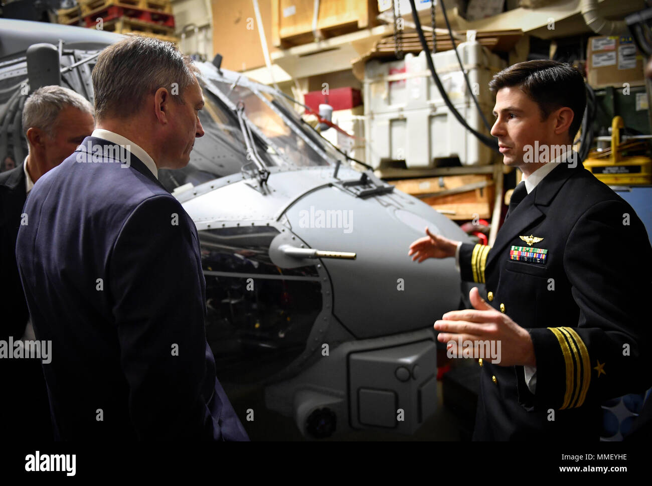 171030-N-UY653-046 OSLO, Norway (Oct. 30, 2017) Lt. Cmdr. Michael Sullivan, right, assigned to the 'Grandmasters' of Helicopter Maritime Strike Squadron (HSM) 46, gives a tour of an MH-60R Sea Hawk helicopter to Norwegian Defense Minister Frank Bakke-Jensen aboard the Arleigh Burke-class guided-missile destroyer USS Oscar Austin (DDG 79). Oscar Austin is on a deployment supporting U.S. national security interests in Europe, and increasing theater security cooperation and forward naval presence in the U.S. 6th Fleet area of operations. (U.S. Navy photo by Mass Communication Specialist 2nd Class Stock Photo