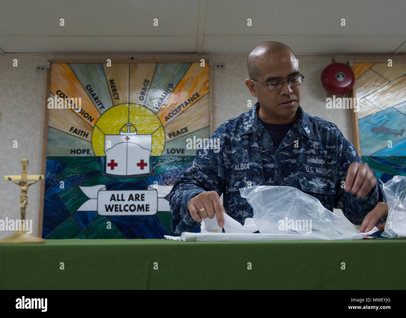 171030-N-MU198-002 SAN JUAN, Puerto Rico (Oct. 30, 2017) Religious Program Specialist 1st Class Adonis Albia prepares the chapel of the Military Sealift Command hospital ship USNS Comfort (T-AH20) for Catholic mass. Comfort is moored pier side in San Juan, Puerto Rico, to provide humanitarian relief. The Department of Defense is supporting the Federal Emergency Management Agency, the lead federal agency, in helping those affected by Hurricane Maria to minimize suffering and is one component of the overall whole-of-government response effort. (U.S. Navy photo by Mass Communication Specialist 3r Stock Photo