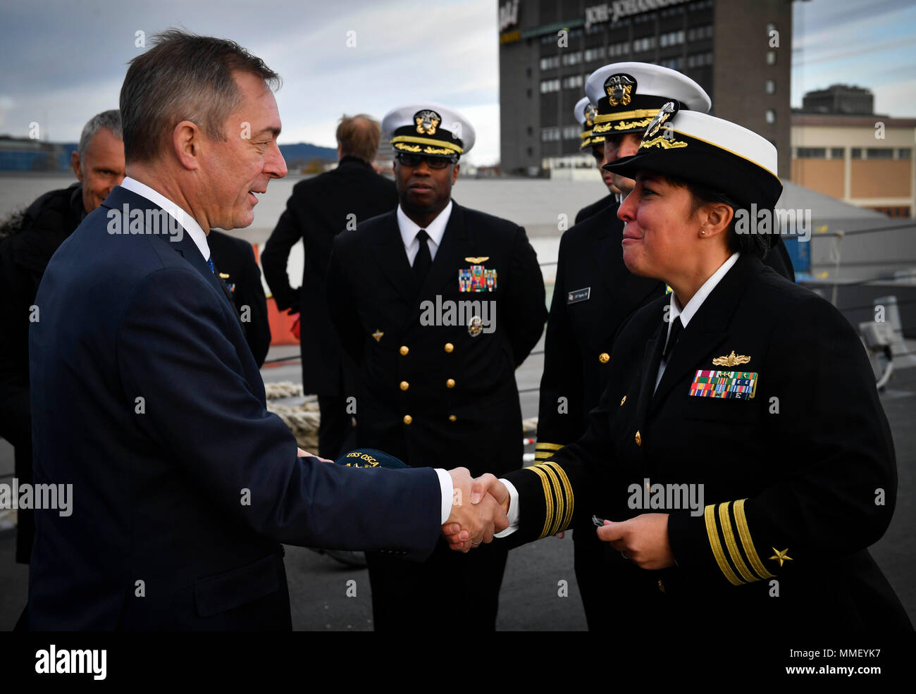 171030-N-UY653-073  OSLO, Norway (Oct. 30, 2017) Cmdr. Samantha Dutily,  commanding officer of the Arleigh Burke-class guided-missile destroyer USS Oscar Austin (DDG 79), shakes hands with Norwegian Defense Minister Frank Bakke-Jensen  Oct. 30, 2017. Oscar Austin is on a routine deployment supporting U.S. national security interests in Europe, and increasing theater security cooperation and forward naval presence in the U.S. 6th Fleet area of operations. (U.S. Navy photo by Mass Communication Specialist 2nd Class Ryan Utah Kledzik/Released) Stock Photo