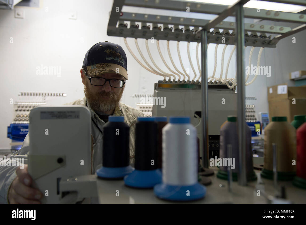 Fred Rhoades, Joint Base Elmendorf-Richardson Laundry embroidery expert, creates name tapes at JBER, Alaska, Oct. 20, 2017. The JBER Laundry employs 63 Airmen who collectively wash, dry, press, fold and wrap 7,000 pounds of laundry daily – almost 7 million pounds per year. The JBER Laundry, formerly known as the Quartermaster Laundry has been supporting the laundry needs of the base community since the 1950s. (U.S. Air Force photo by Senior Airman Javier Alvarez) Stock Photo