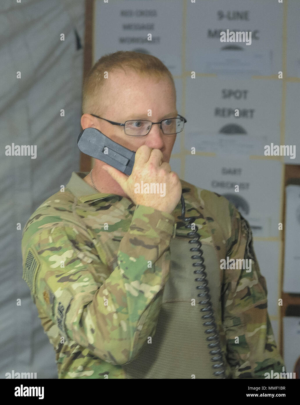 CAMP BUEHRING, Kuwait – Maj. Nathaniel Dibling, 449th Aviation Support Battalion executive officer, performs a radio check with the ASB’s subordinate units during the brigade support area defense exercise at Camp Buehring, Kuwait, Oct. 21, 2017.The 449th ASB increased its readiness and performed mission essential tasks during the BSA exercise. (U.S. Army photo by Capt. Stephen James) Stock Photo