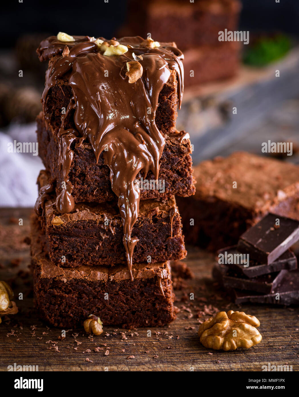 a stack of baked brown brownie pie, dessert is poured with a thick layer of chocolate, close up Stock Photo