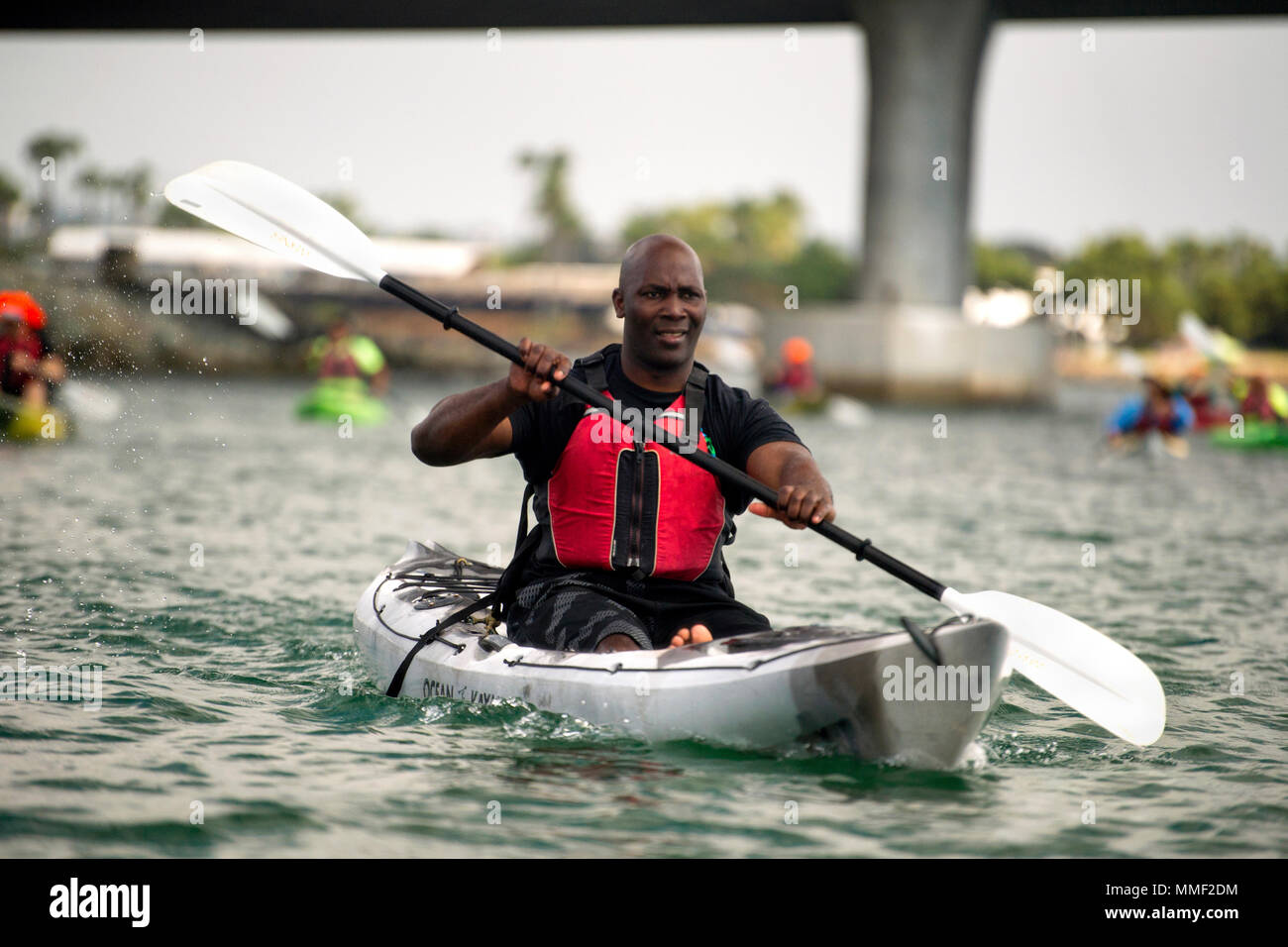 Navy Petty Officer 1st Class Michel Muller paddles a kayak in Mission Bay during an outing for Naval Medical Center San Diego patients in San Diego, Calif. Sept. 19, 2017.  (DoD photo by EJ Hersom) Stock Photo