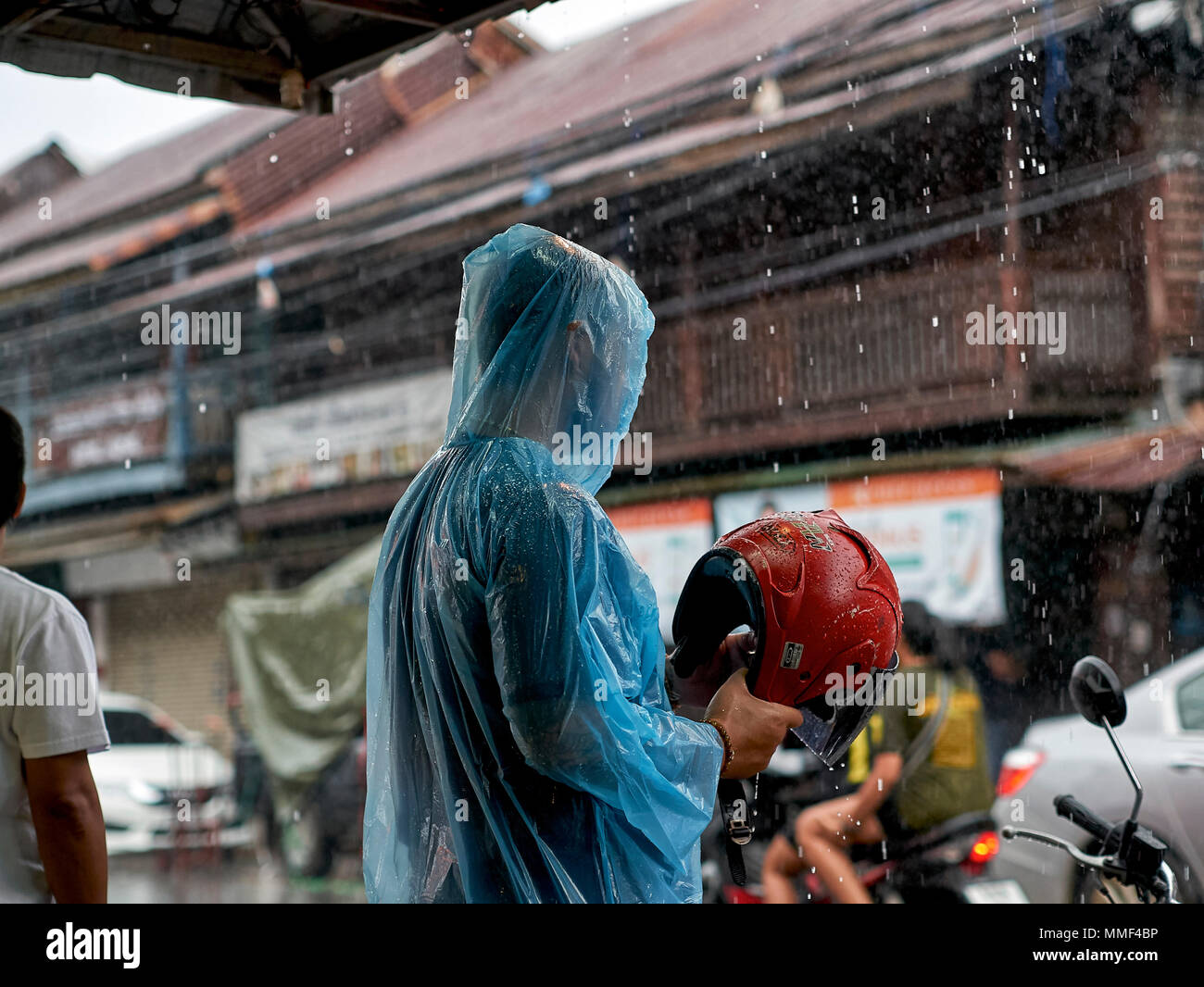 Rain. motorbike rider in torrential rainfall. Thailand monsoon season