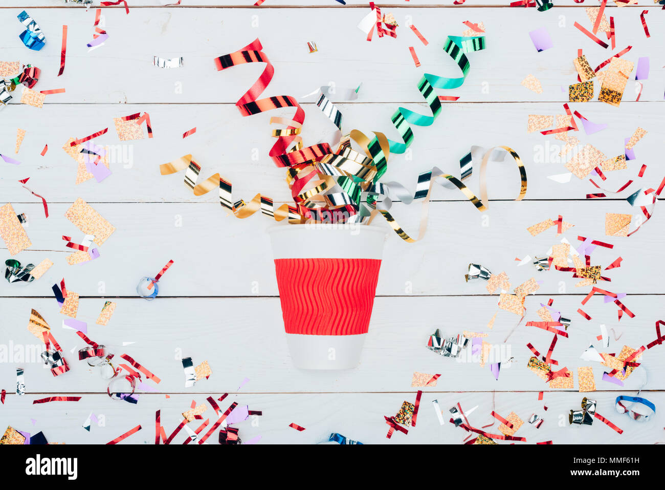 confetti spilling out of paper cup Stock Photo - Alamy