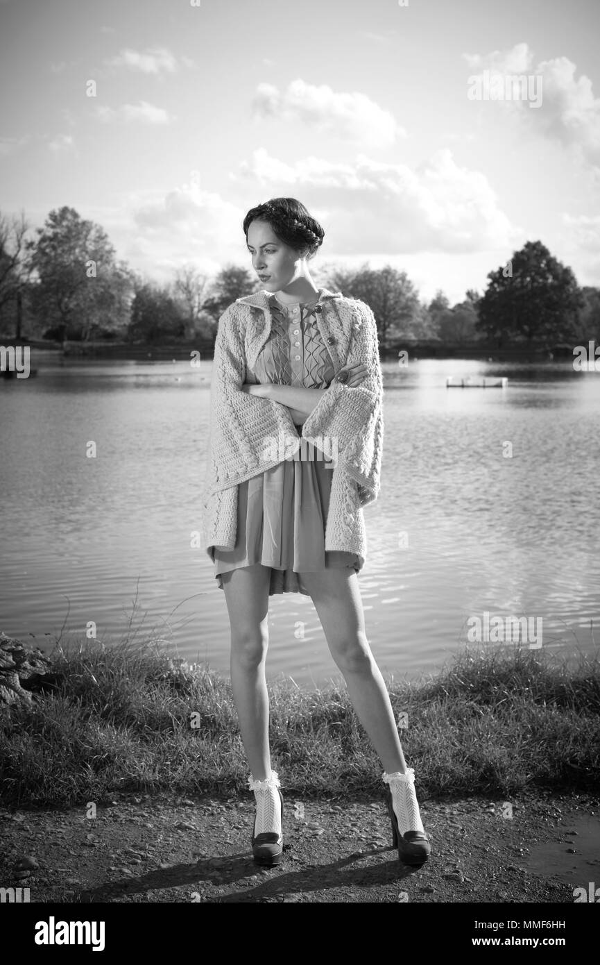Model wearing eco fashion clothes next to a pond Stock Photo