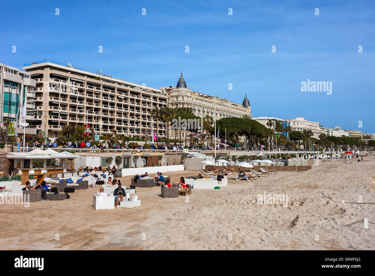 France, Cannes city, beach with sun loungers on French Riviera, buildings along Boulevard de la Croisette Stock Photo