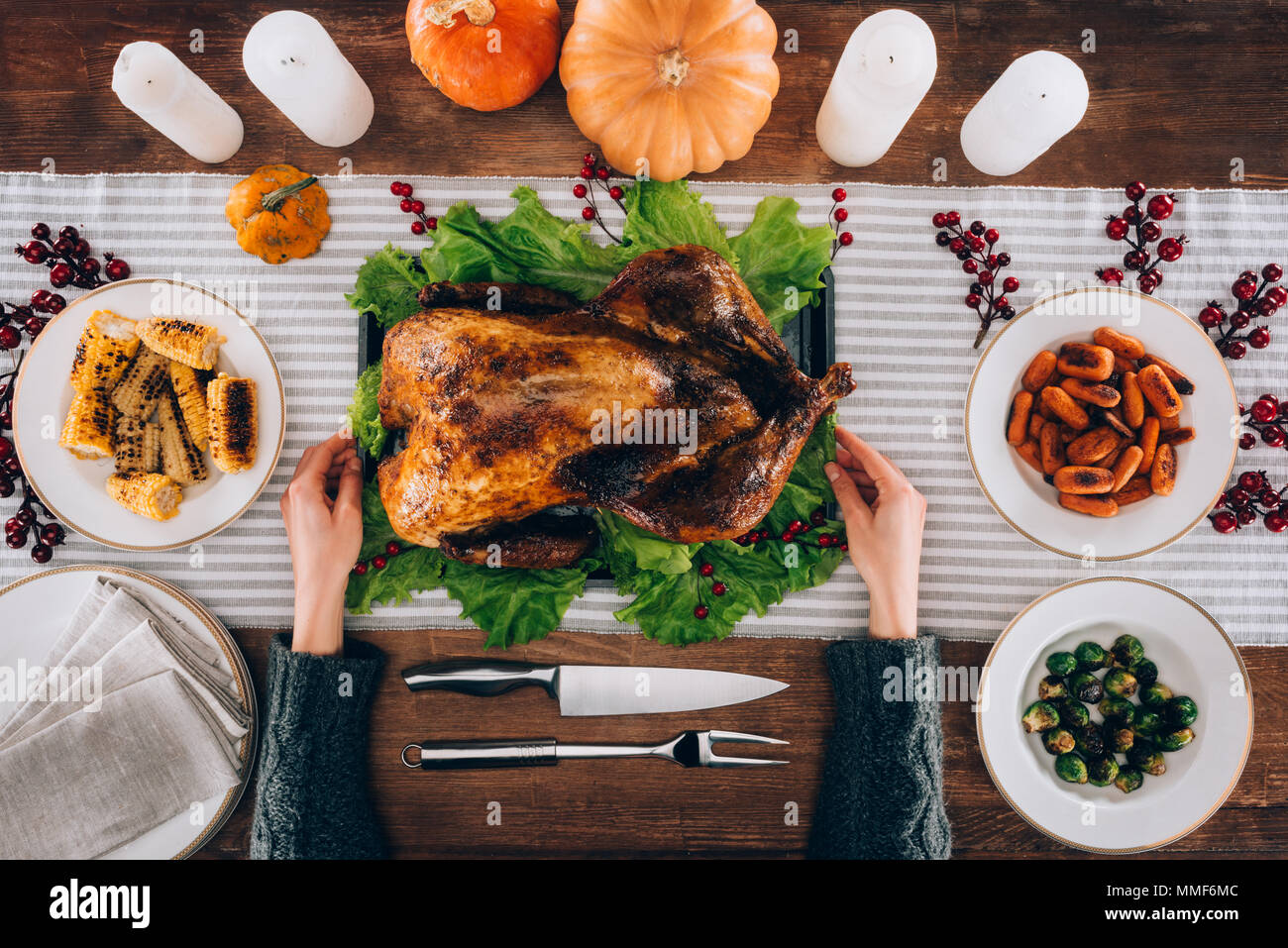 Man serving baked turkey on table Stock Photo