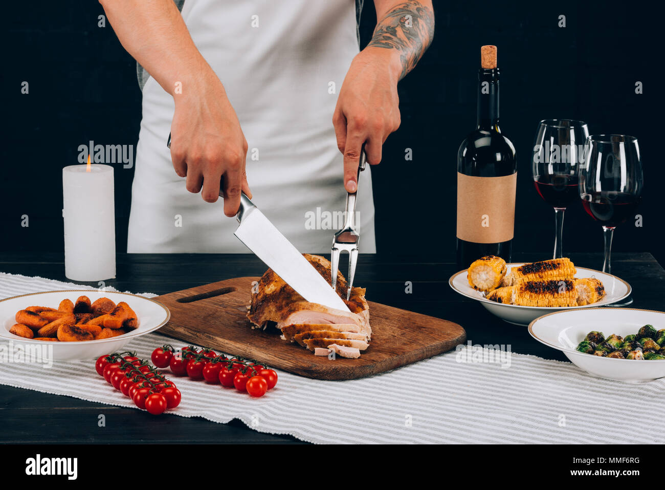 Man cutting turkey on thanksgiving day Stock Photo