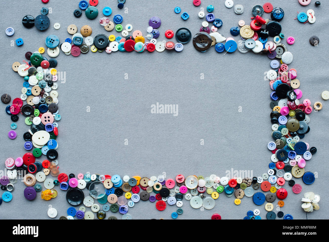 top view of colorful buttons frame on grey cloth background Stock Photo ...