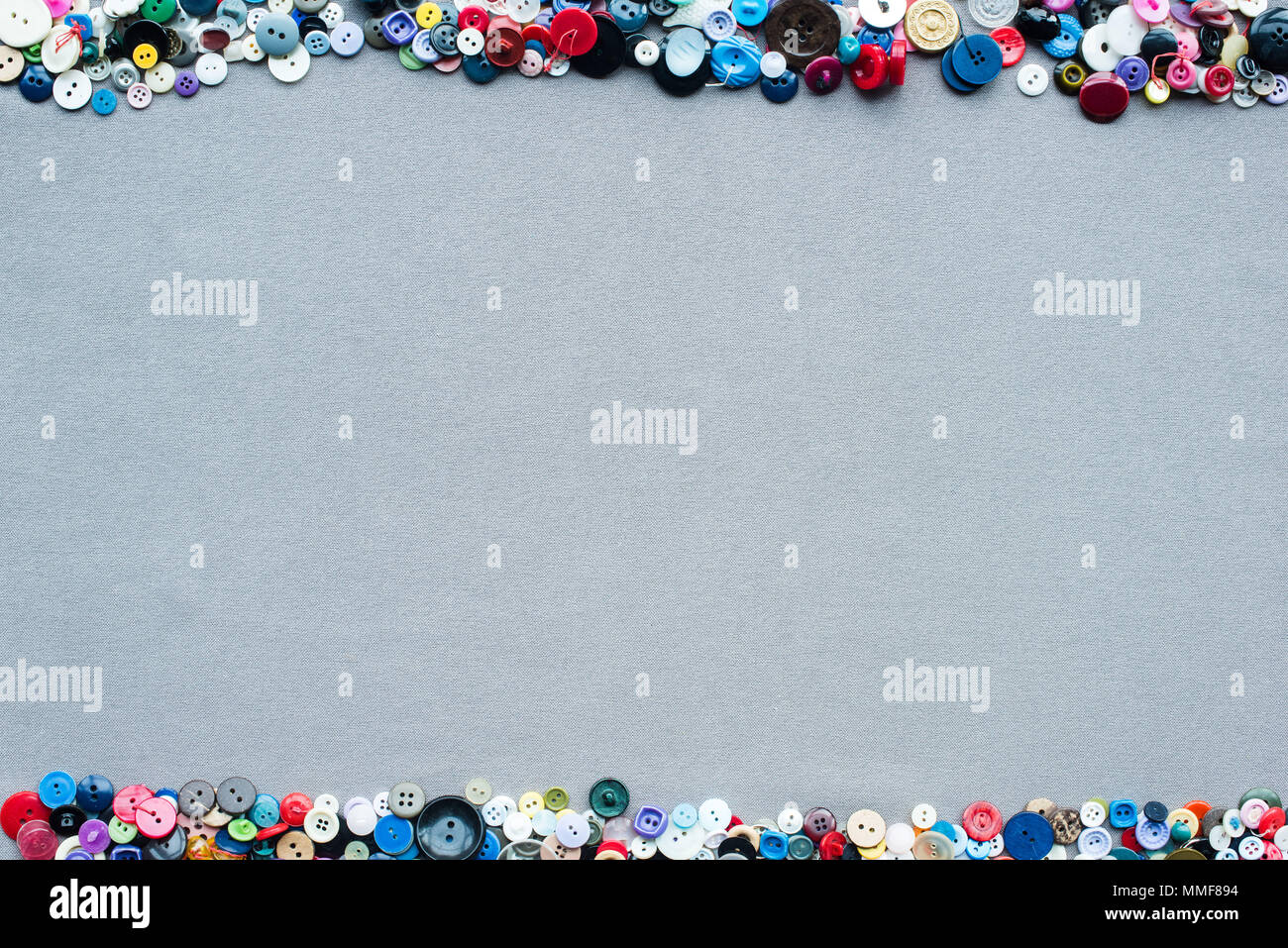 top view of colorful buttons frame on grey cloth background Stock Photo ...