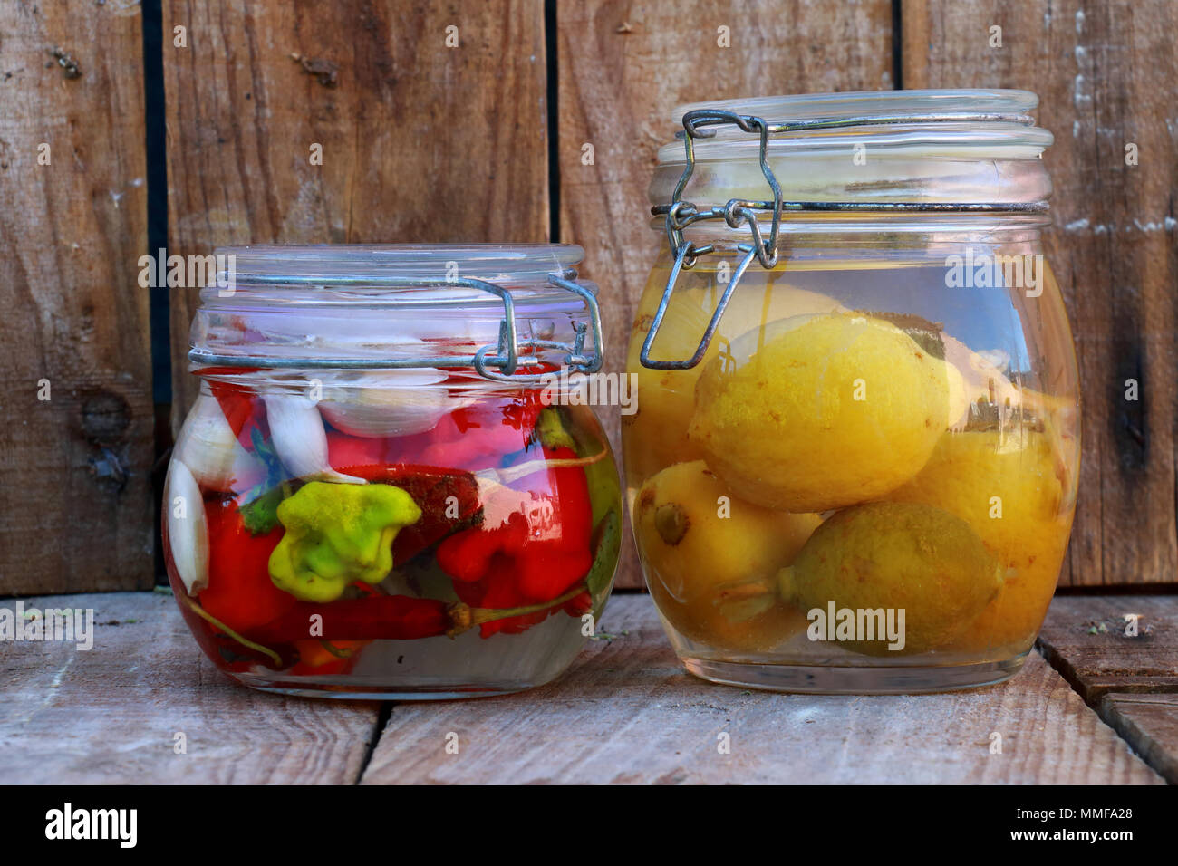 Glass jars with homemade preserved lemons and peppers Stock Photo Alamy