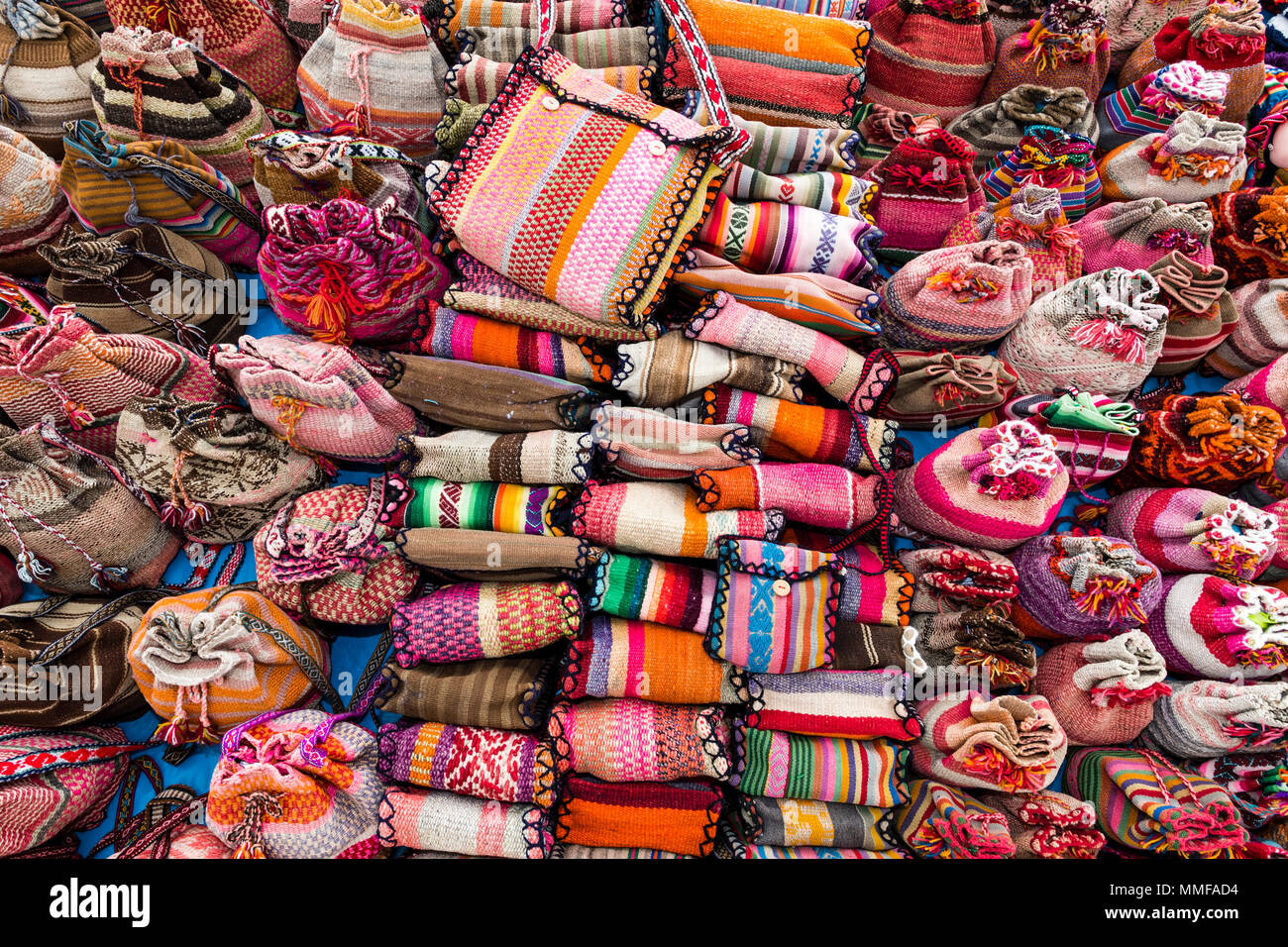 Brightly colored bags and purses for sale to tourists in a Andean village market. Stock Photo