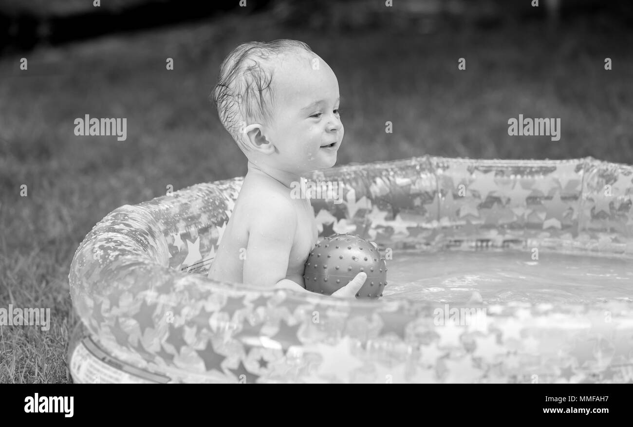 Baby smiling in swimming pool Black and White Stock Photos & Images - Alamy