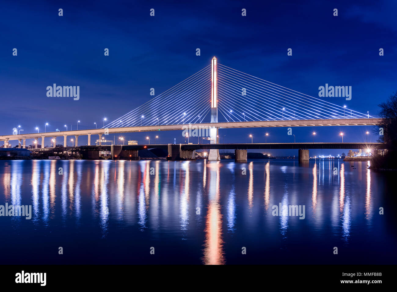 Night view of the Veterans' Glass City Skyway bridge in Toledo Ohio.  The bridges center pylon is lit up with LED lighting. Stock Photo