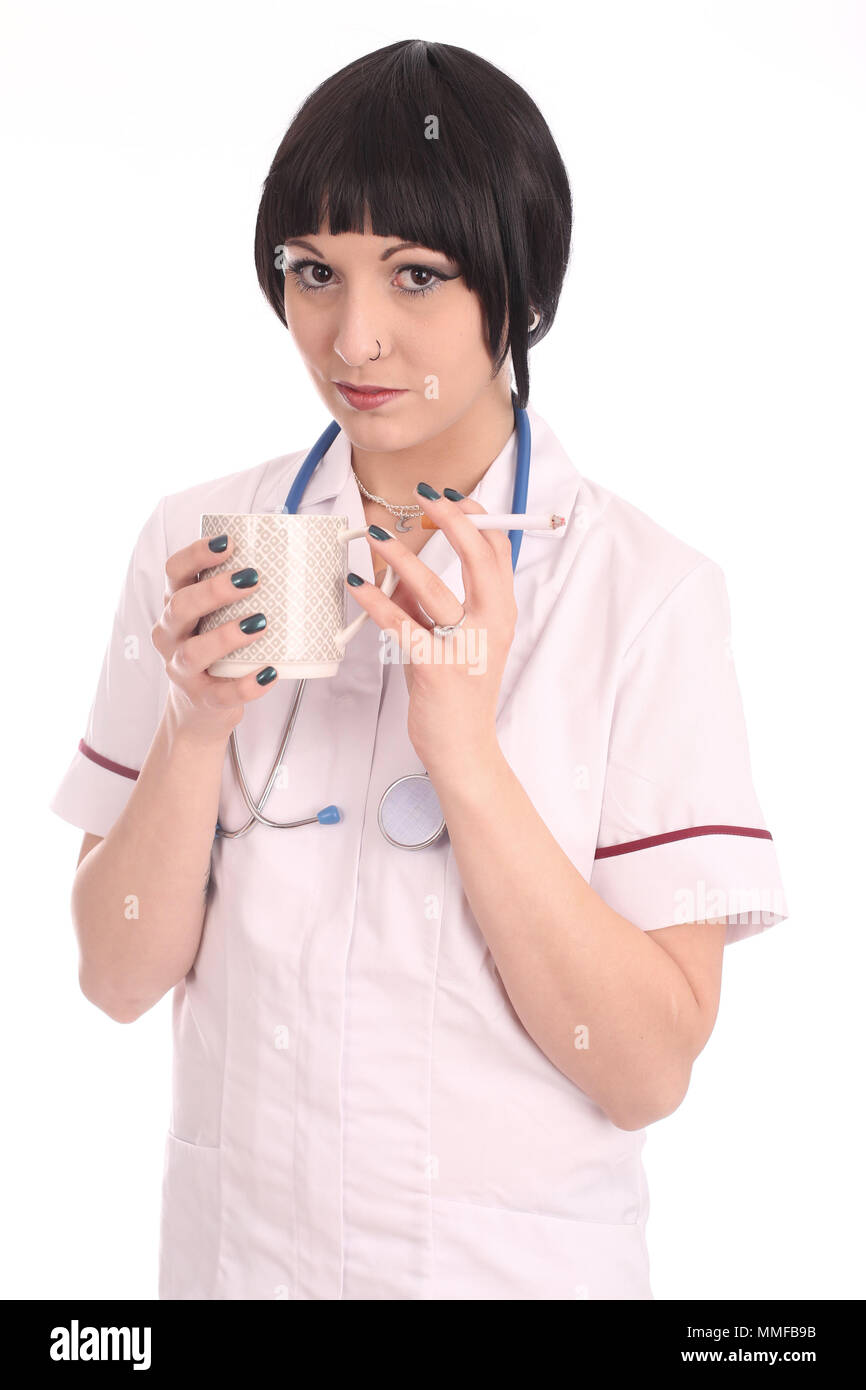 May 2015 - Young nurse taking a break, a coffee and a cigarette. Stock Photo