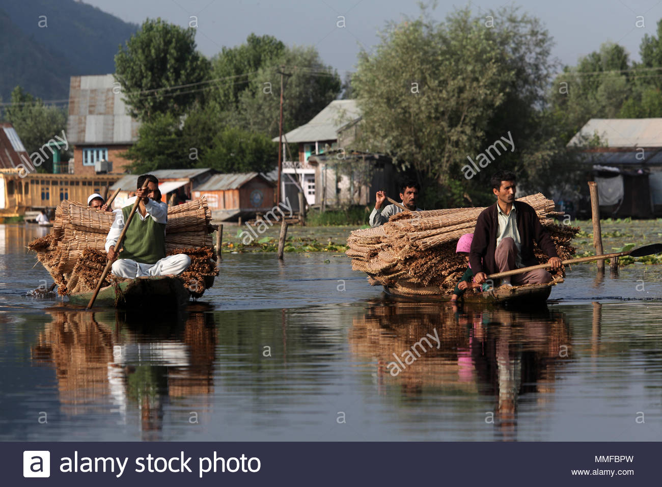 Kashmiri Boatmen Paddle Small Boats Filled With Handmade Reed Mats