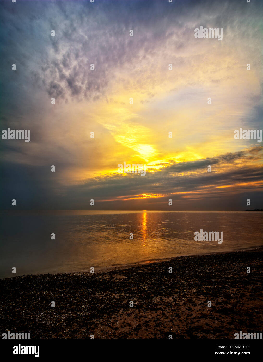 Beautiful sunrise over Lake Erie from Magee Marsh  in Northwest Ohio. Davis-Besse nuclear power plant can be seen in the distance. Stock Photo