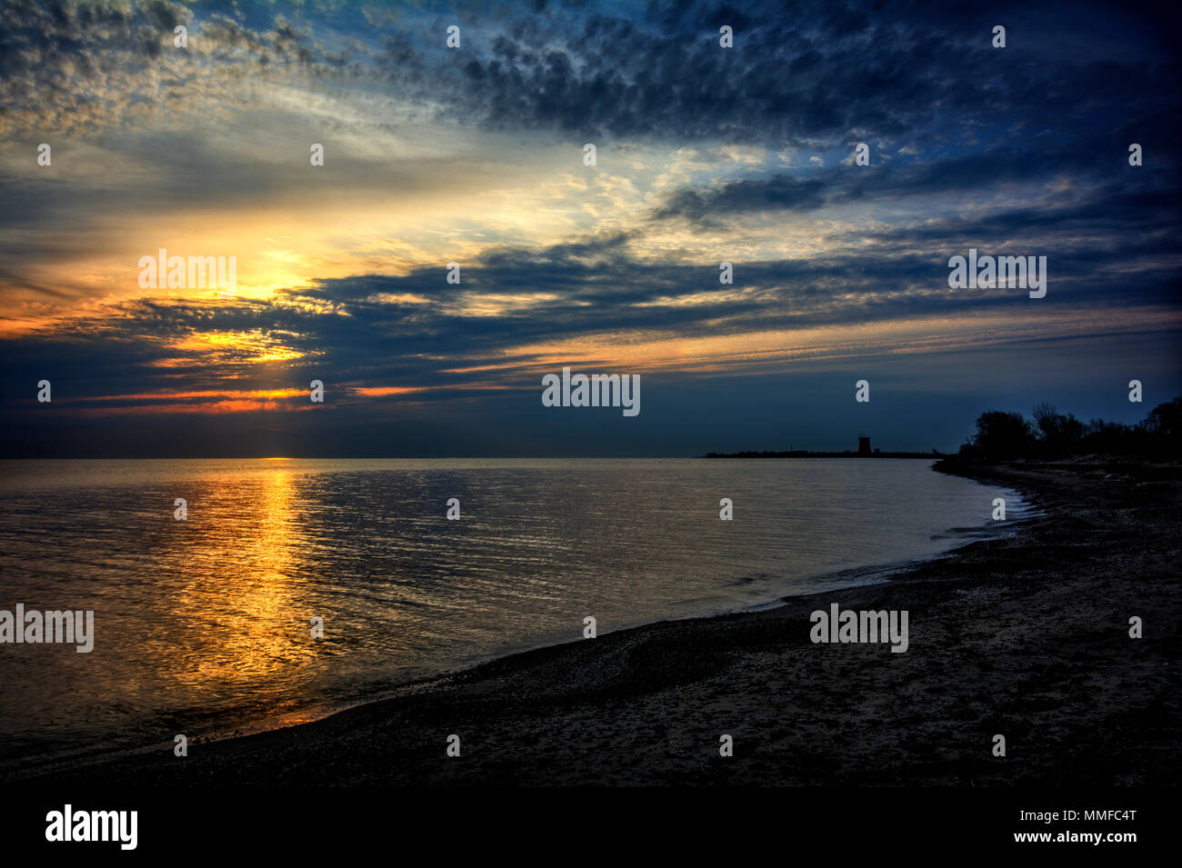 Beautiful vibrant sunrise over Lake Erie from Magee Marsh Ohio. DavisBesse nuclear power plant