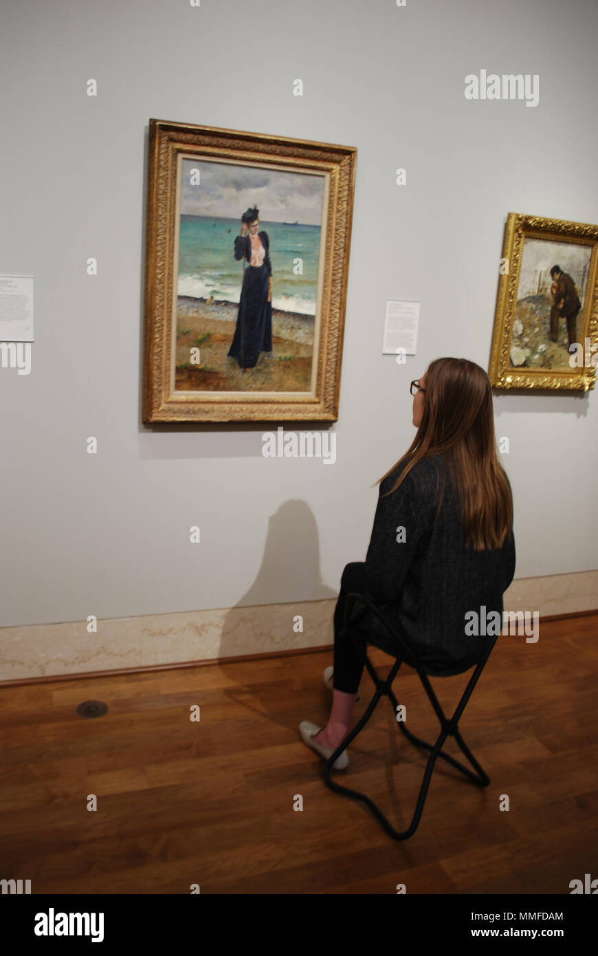 Girl watching at famous art canvas in museum . Concept of curiosity, education, intelligence, pastime. Stock Photo