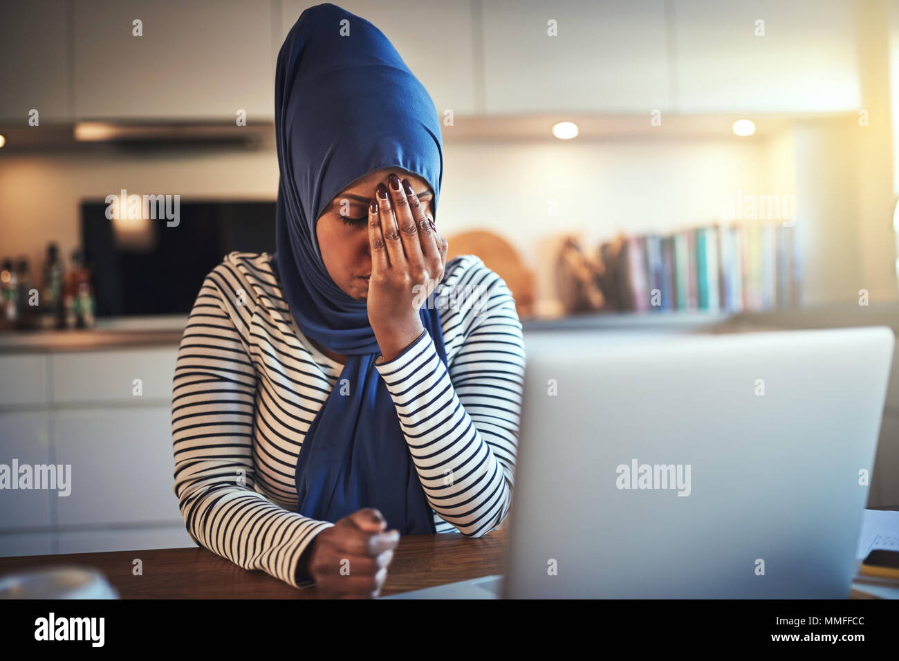 Stressed out young Arabic female entrepreneur wearing a hijab sitting ...