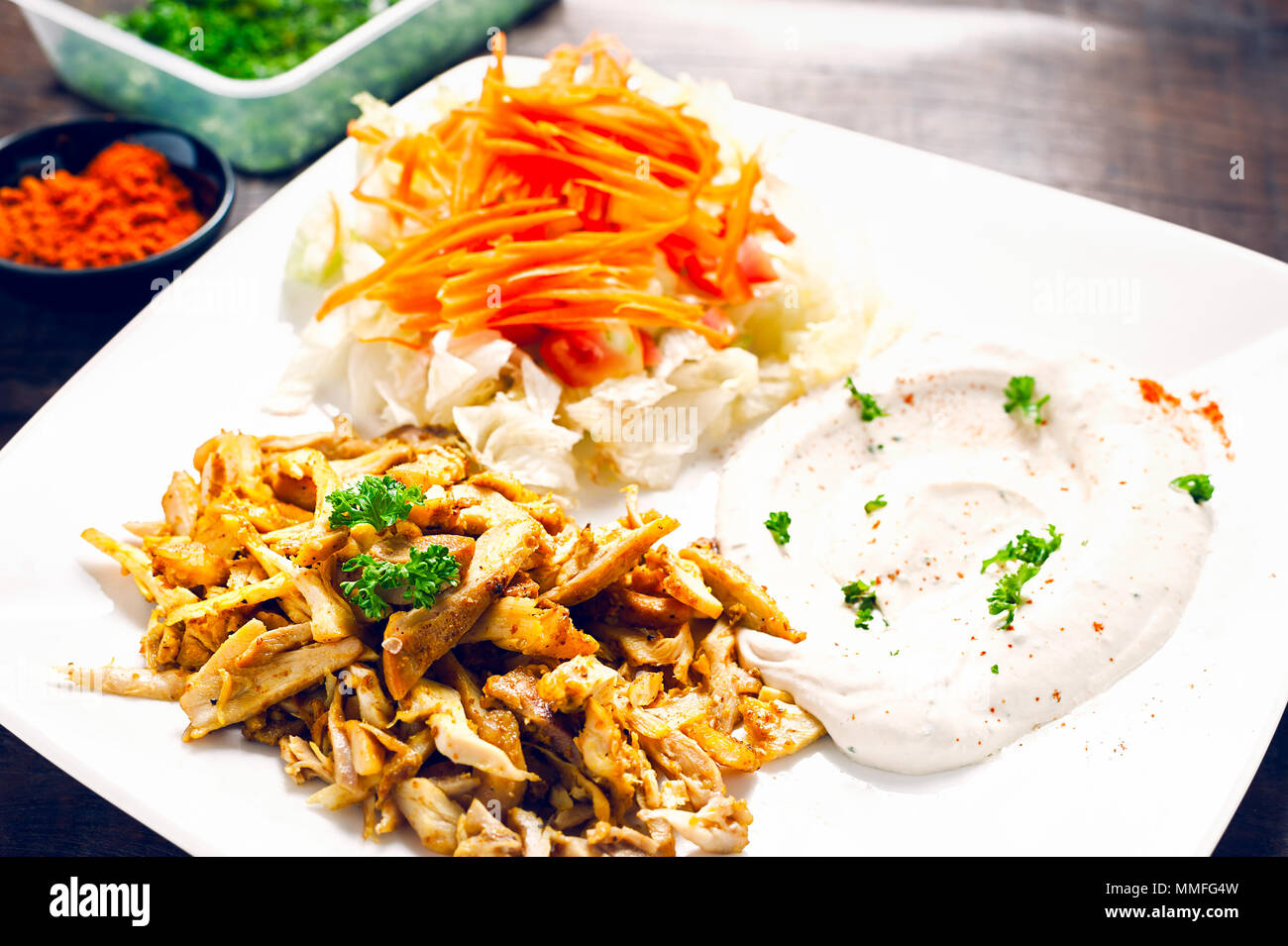 Chicken Shawarma or Doner Kebab serving with hummus and vegetable in