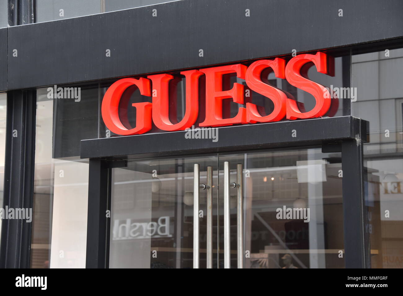 10 May 2018, Germany, Cologne: The logo of fashion and retail company GUESS  is attached to
