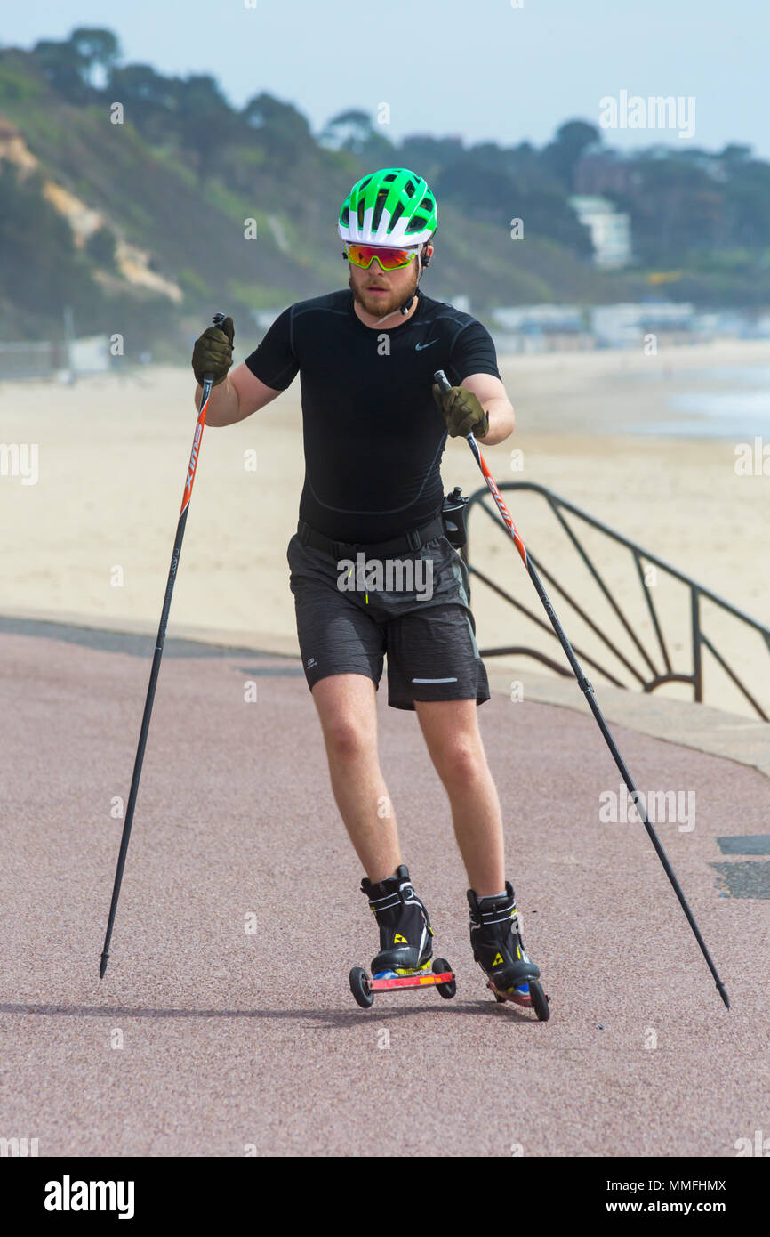 Poole, Dorset, UK. 11th May 2018. UK weather: breezy sunny day at Poole as  a man is roller skiing along the promenade. Roller skiing is an off-snow  equivalent to cross-country skiing. Credit: