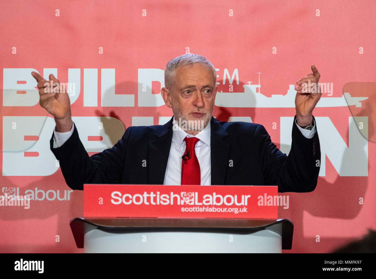 Glasgow, UK. 11 May, 2018. Labour Leader Jeremy Corbyn giving a speech in Govan, Glasgow in which he said that a Labour government will proactively support UK shipbuilding as part of a wider industrial strategy and called on the Conservative Government to guarantee three new Royal Fleet Auxiliary vessels will be built in domestic shipyards. Credit: Iain Masterton/Alamy Live News Stock Photo