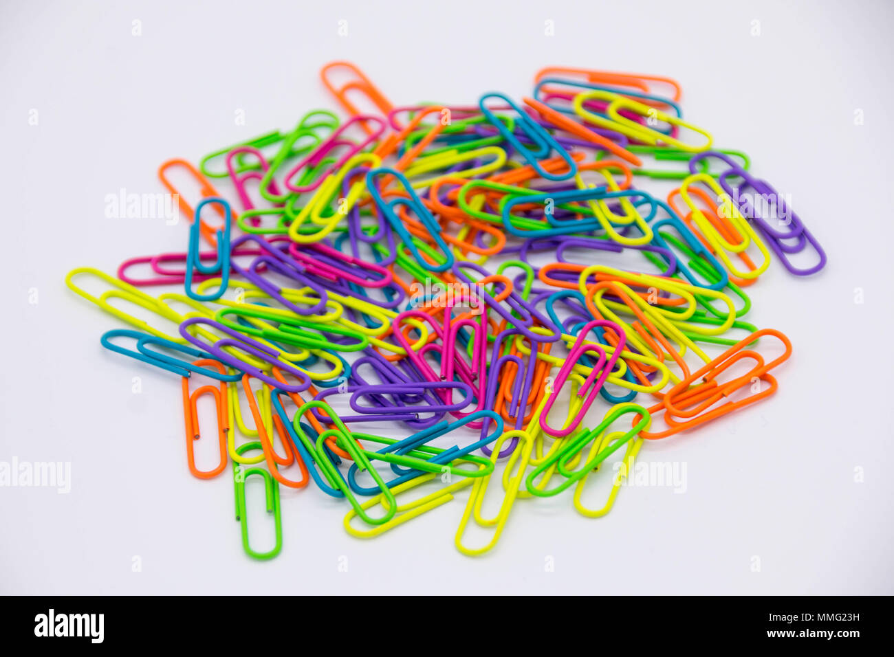 Colourful neon paper clips / fasteners isolated on a white background Stock Photo