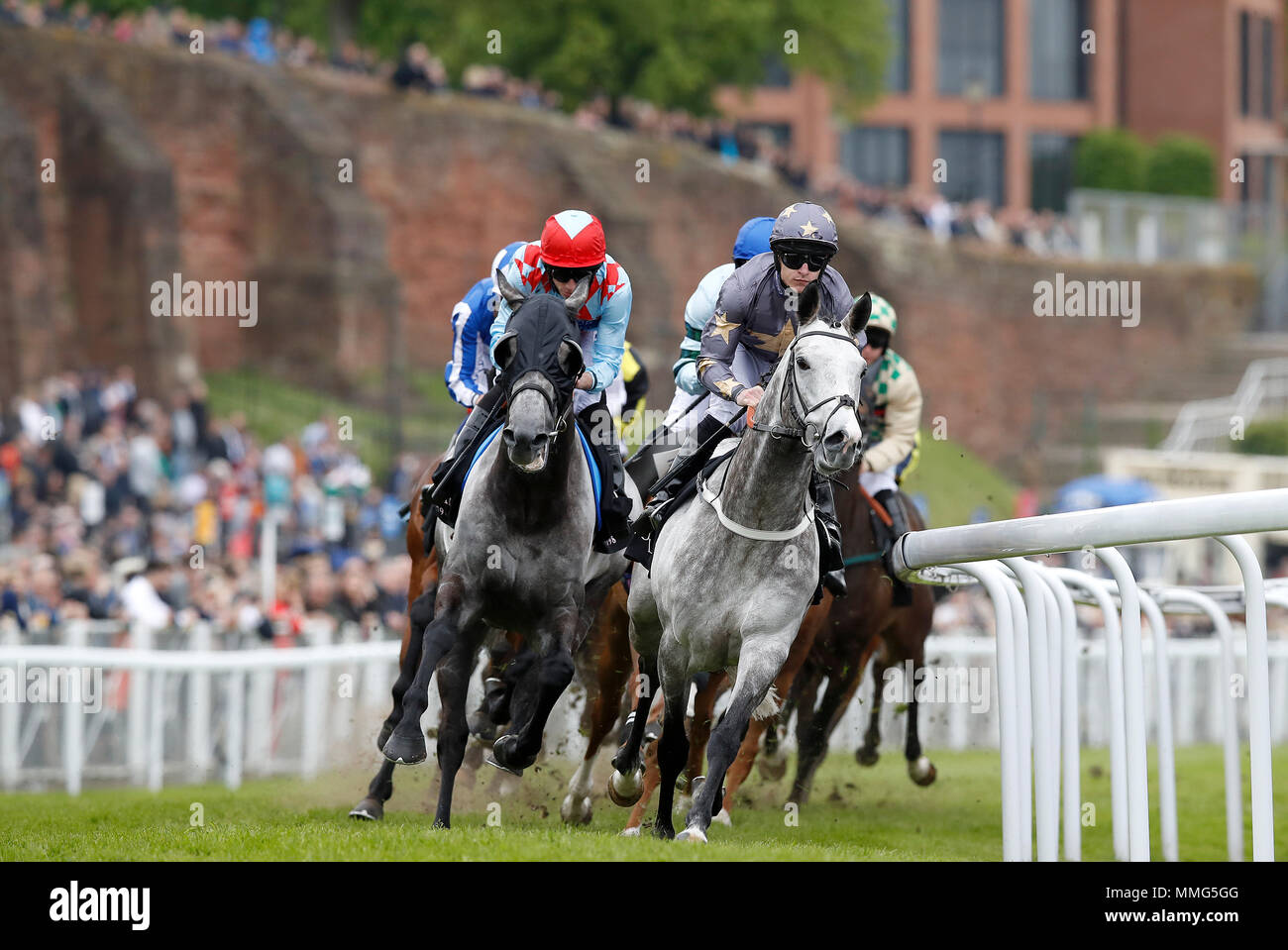 Restorer (right) ridden by Richard Kingscote on their way to winning The Boodles Diamond Handicap Stakes, during 188BET Chester Cup Day of the 2018 Boodles May Festival at Chester Racecourse. Stock Photo