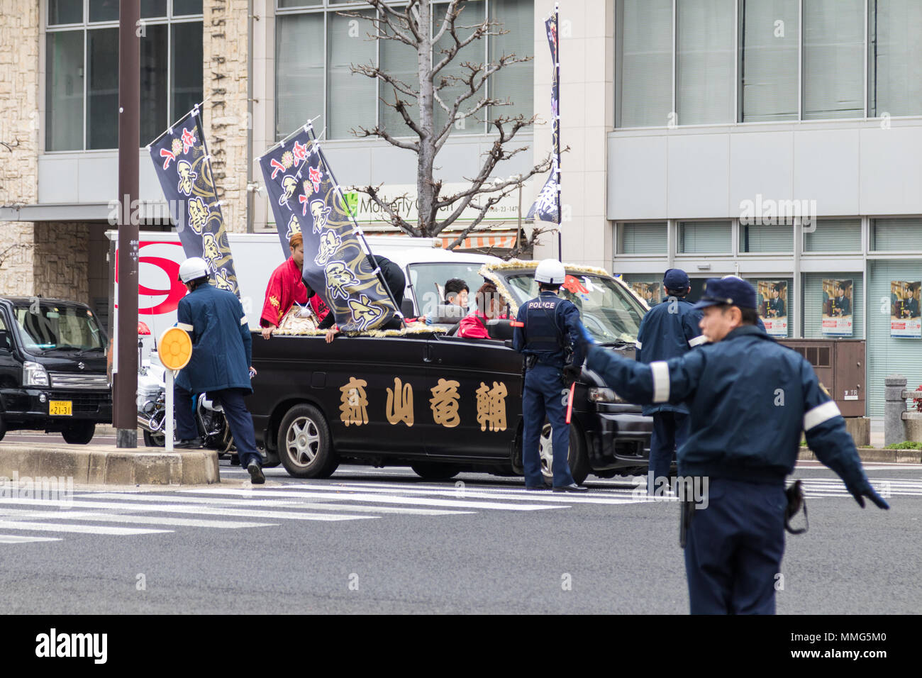 Sasebo, Japan - 07JAN2018: Japanese police directing traffic during the coming of age day celebration in Japan. Stock Photo