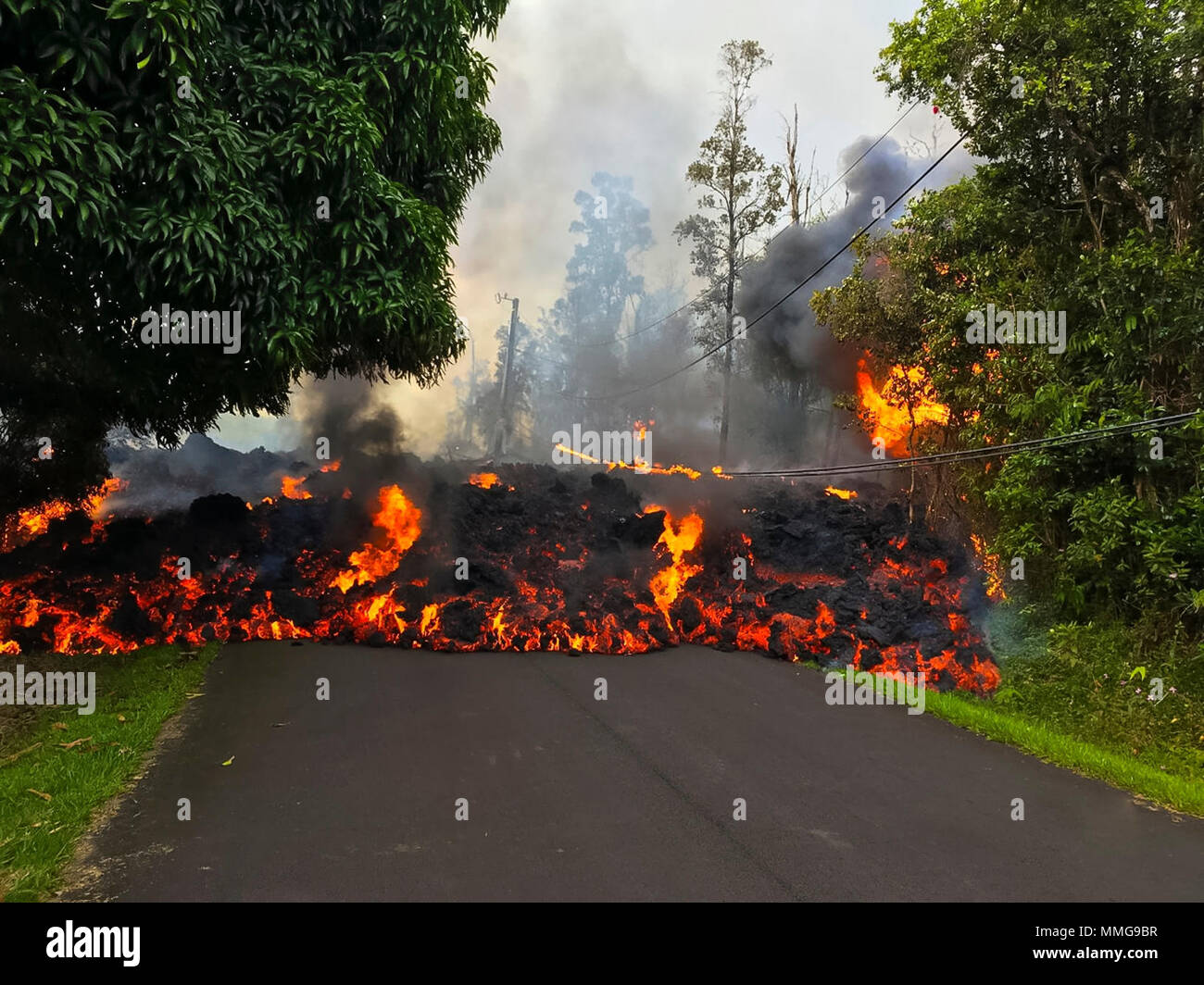Hawaii volcano eruption lava flow in road. Stock Photo