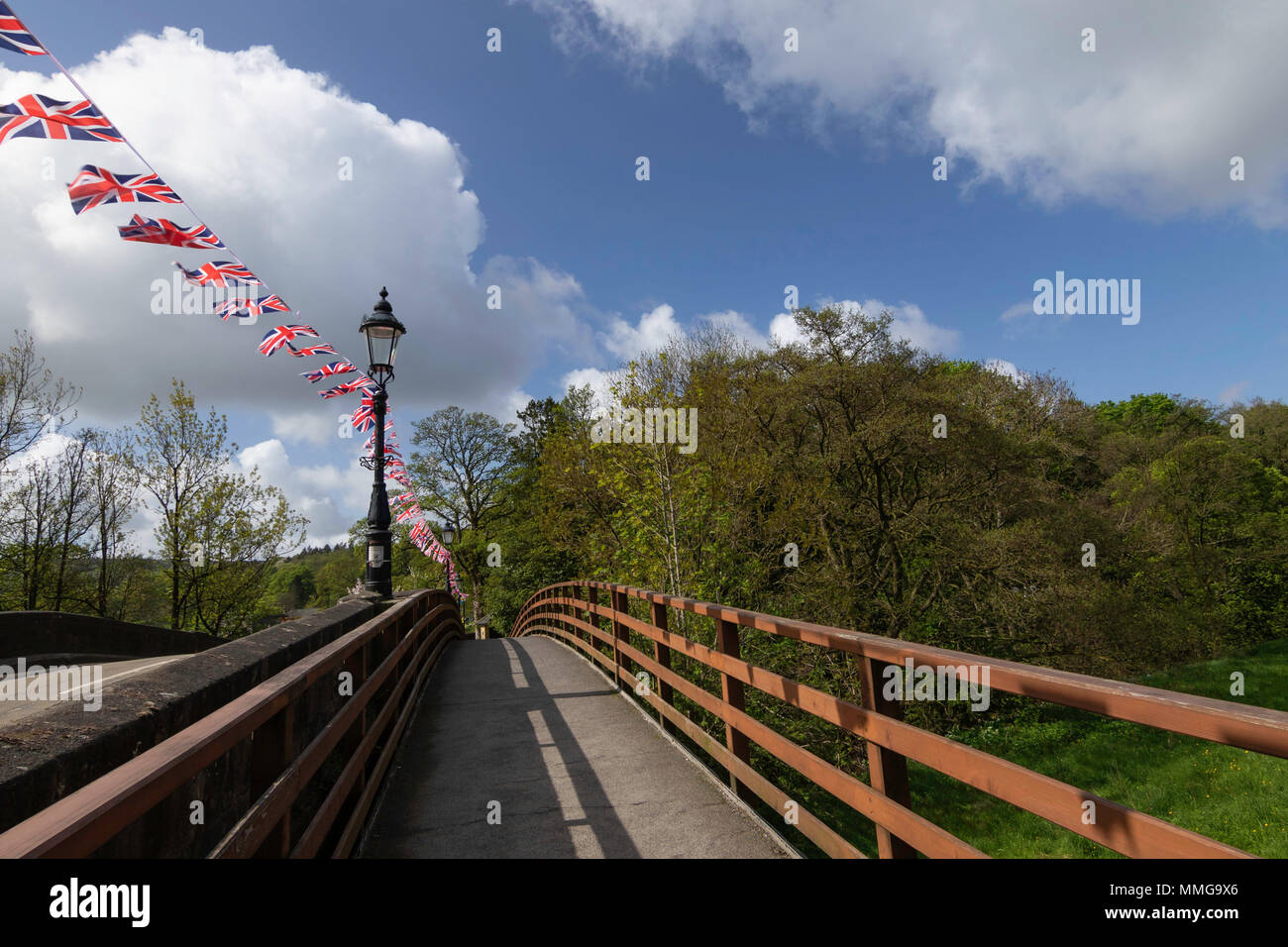 Union Jacks flying across the bridge over the River Nidd, Pateley Bridge, Nidderdale, North Yorkshire, England, UK. Stock Photo