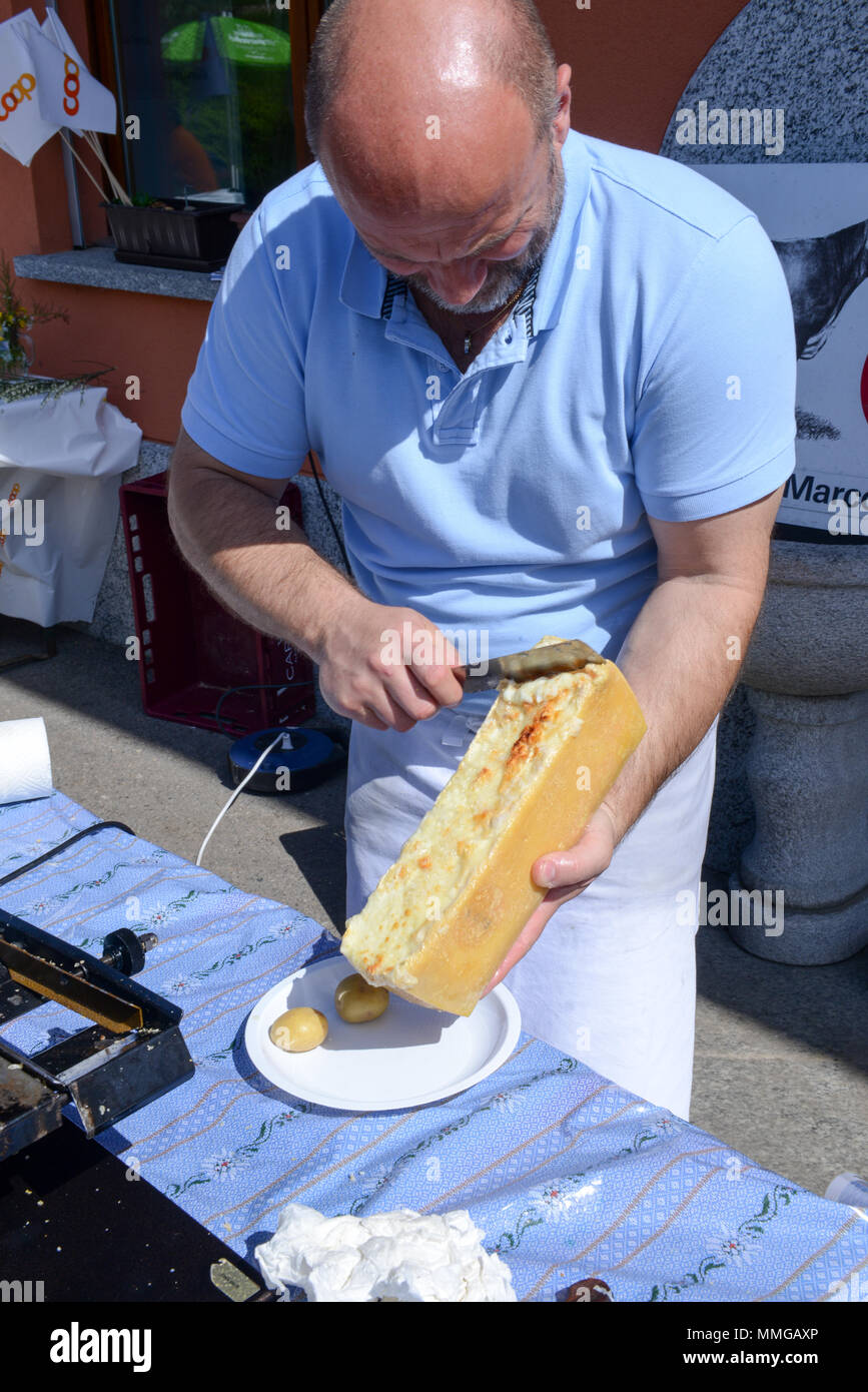 Mugena, Switzerland - 7 May 2018: man preparing a portion of raclette at  Mugena on the Swiss alps Stock Photo - Alamy