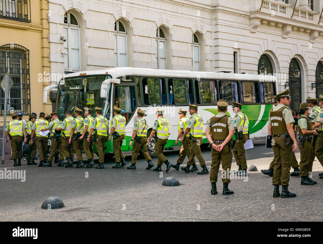 Good Friday, Carabineros or Chilean police in a line boarding a bus, Plaza de Armas, Santiago, Chile, South America Stock Photo